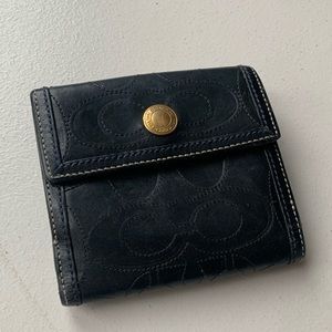 Black original Coach wallet has multiple card pockets, change and paper pockets